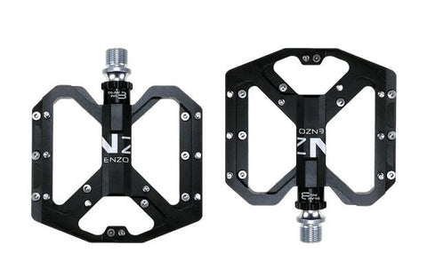 NEXT GEN ENZO flat foot mountain bike pedals in black colour. Top view against white background.