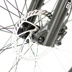 Close up of the front wheel rotor of the Eunorau Specter S Electric Mountain bike against a blurred white background.
