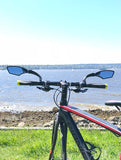 Azur anti-glare blue rearview mirrors fitted on a mountain bike with sea view background.