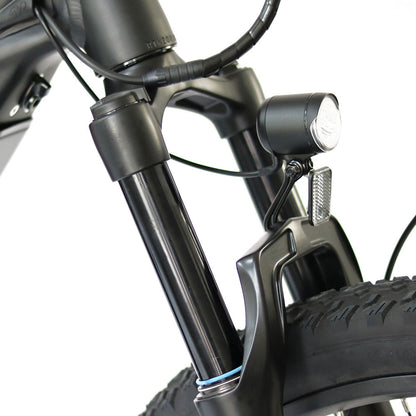 Close up of the Eunorau Specter ST electric mountain bike front suspension and front lights. White background.