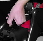 Bellelli B One Clamp rear child seat close up of hand unfastening the  seat harness buckle.