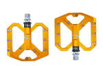NEXT GEN ENZO flat foot mountain bike pedals in gold colour. Top view.