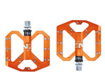 NEXT GEN ENZO flat foot mountain bike pedals in orange colour. Top view.